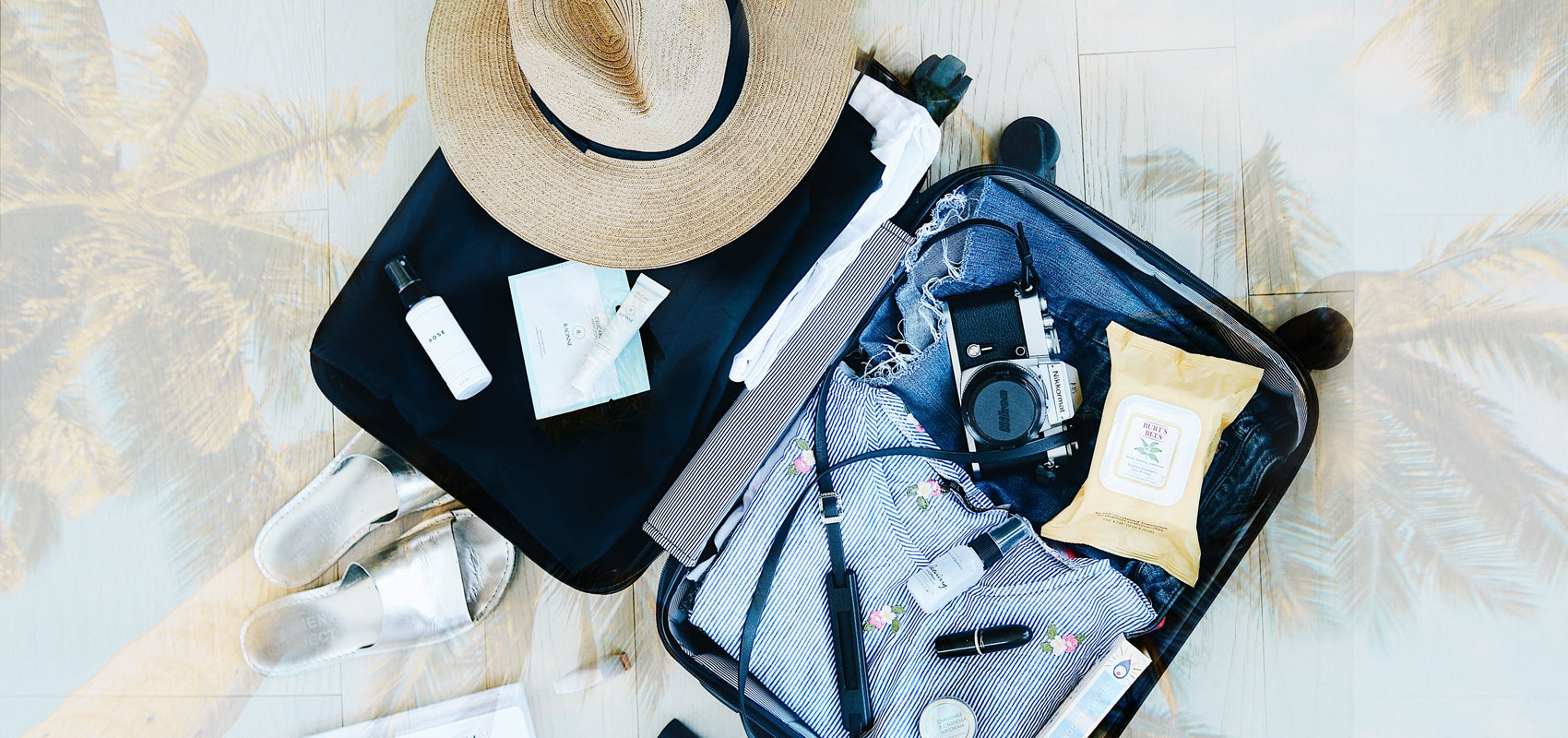 open suitcase with honeymoon items inside