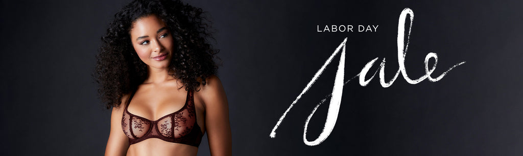 Female model wearing the Journelle Romy Demi Bra with Journelle Labor Day Sale Graphic
