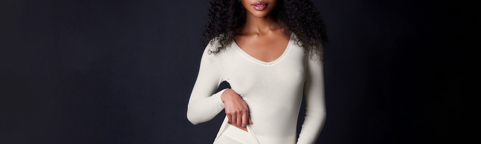 Female model wearing the Collezione Privata Fine Rib V Neck Long Sleeve