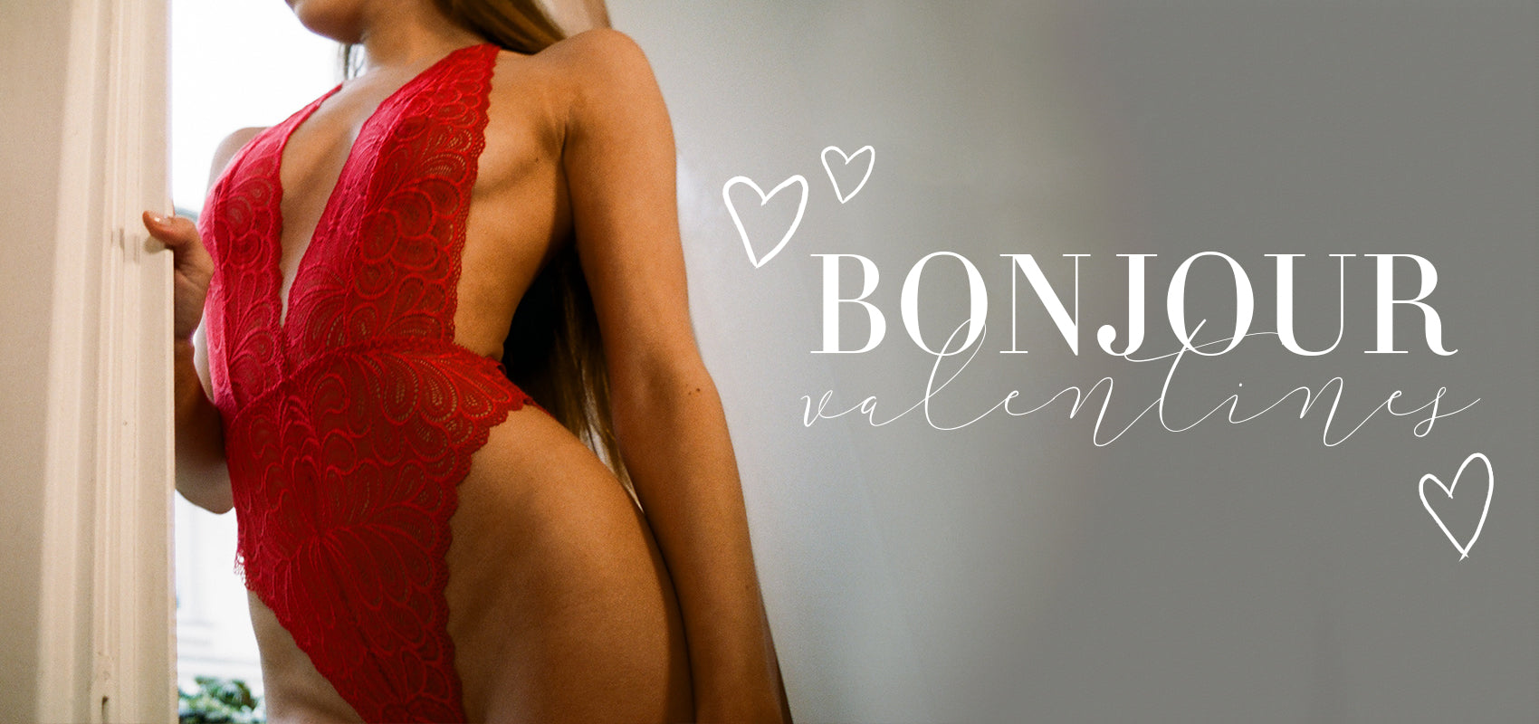 Woman standing in doorway wearing Karina Bodysuit in Rouge