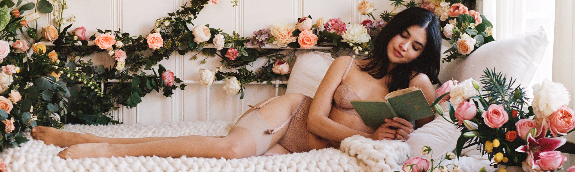 Female model wearing the Journelle Allegra Balconette Bra, Suspender, and Thong